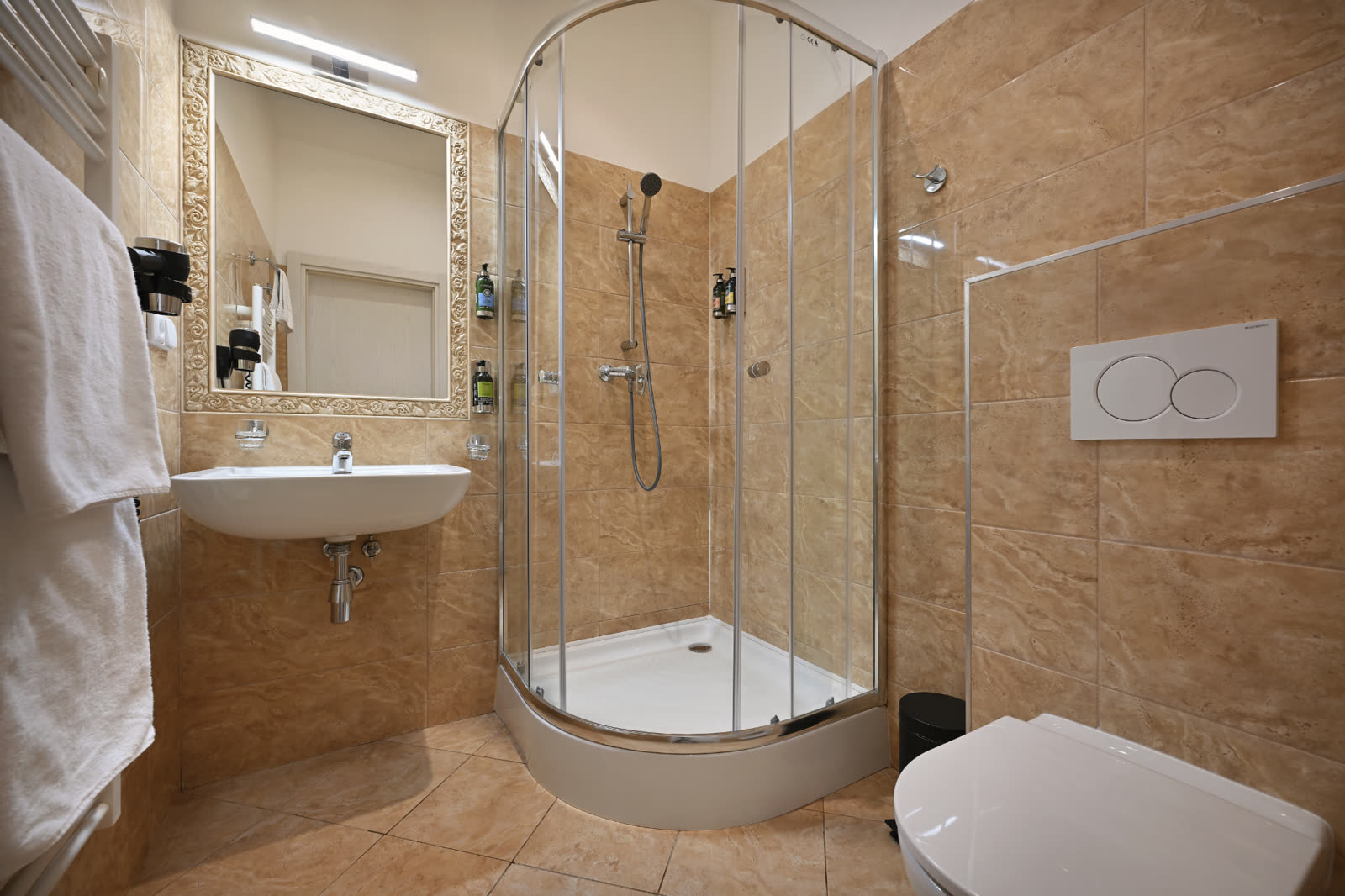 Modern bathroom with walk-in shower and bath amenities