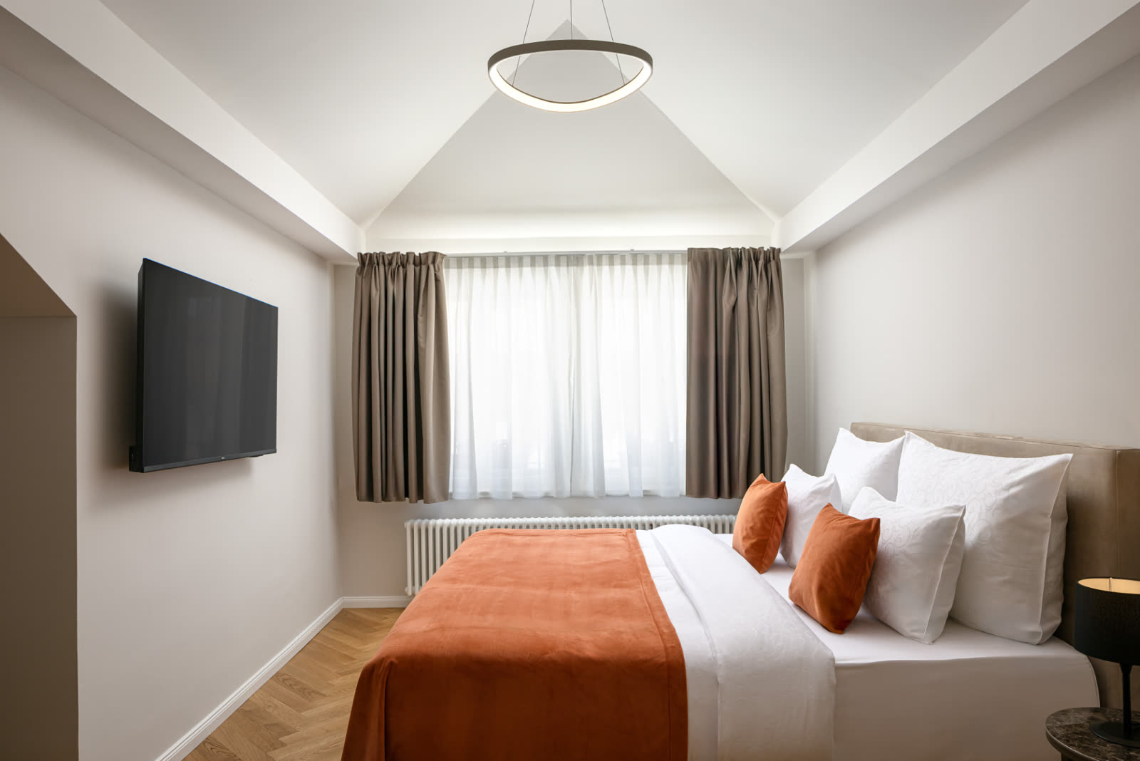 Bedroom with vaulted ceiling and smart TV