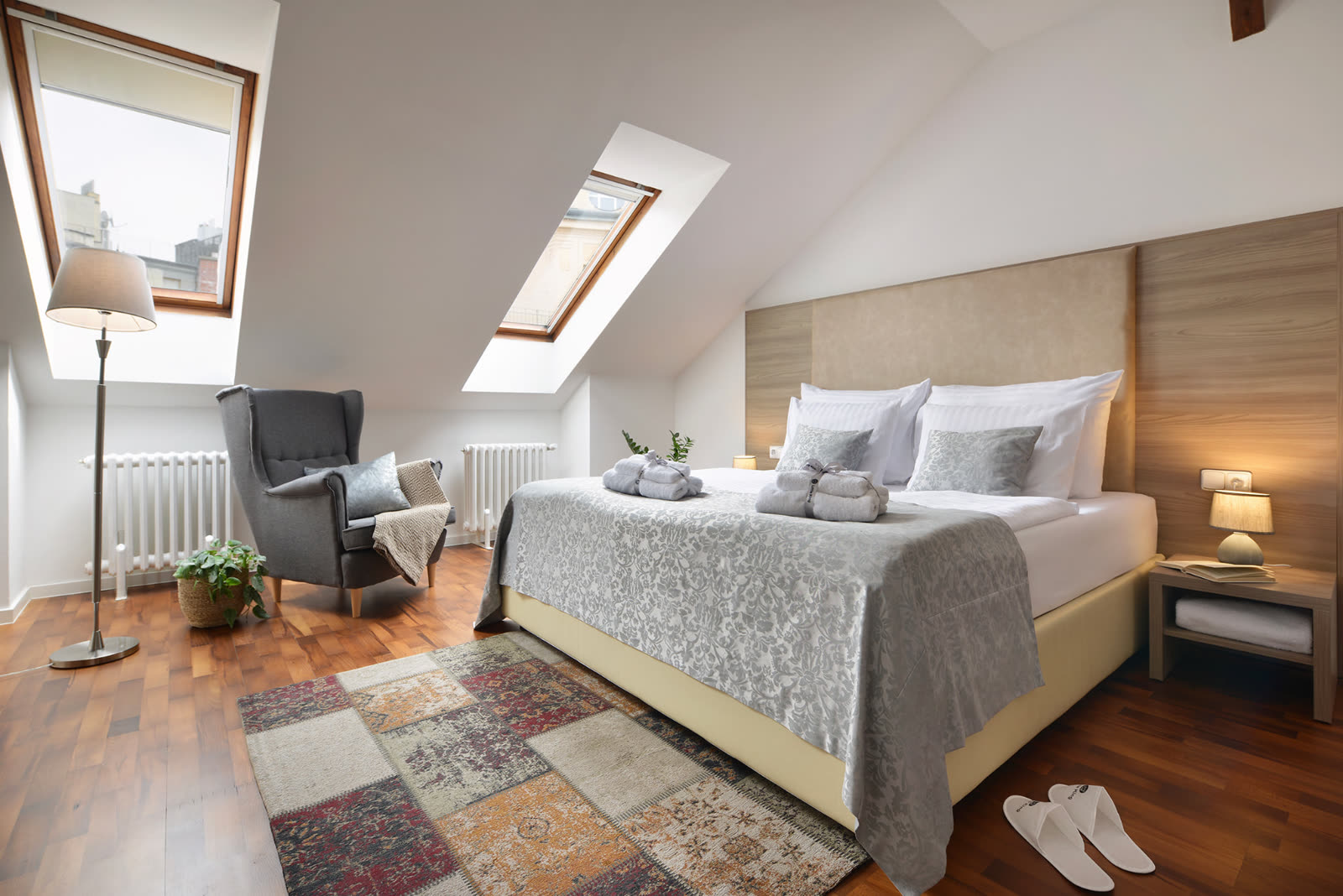 Attic apartment with skylights and armchair at Old Town Residence