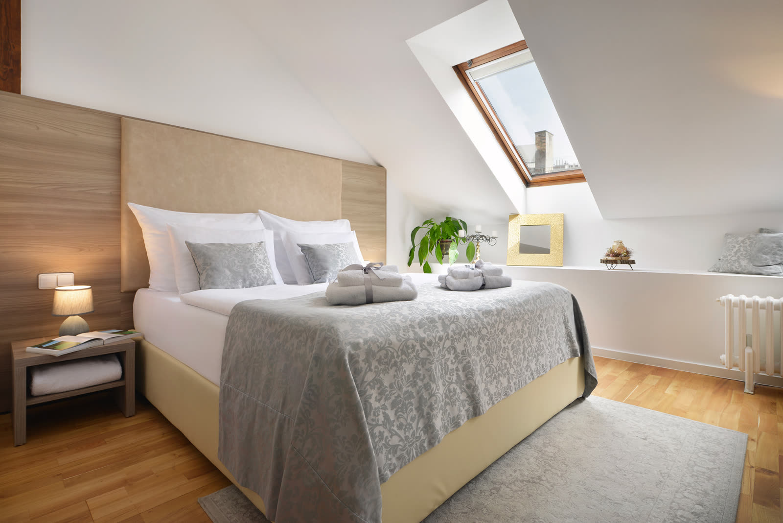 Attic bedroom with skylight and premium bedding