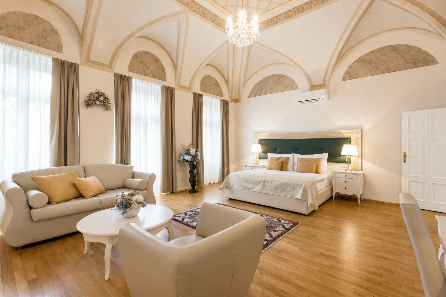 Vaulted suite with chandelier and lounge seating at U Malvaze