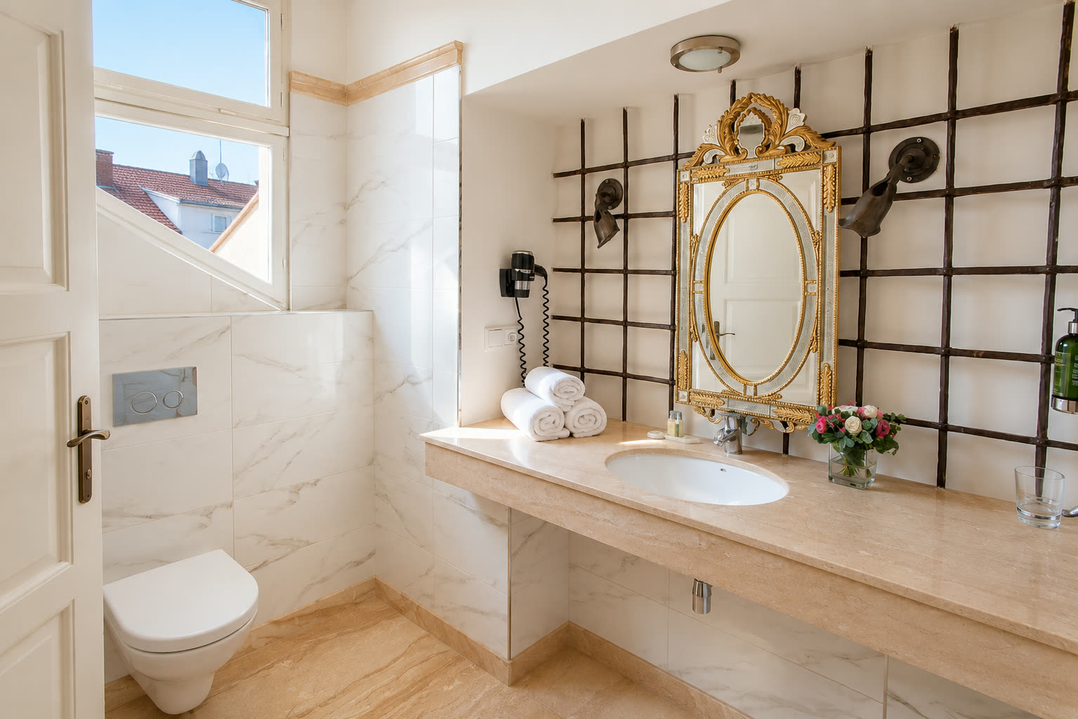 Marble bathroom with gilded mirror